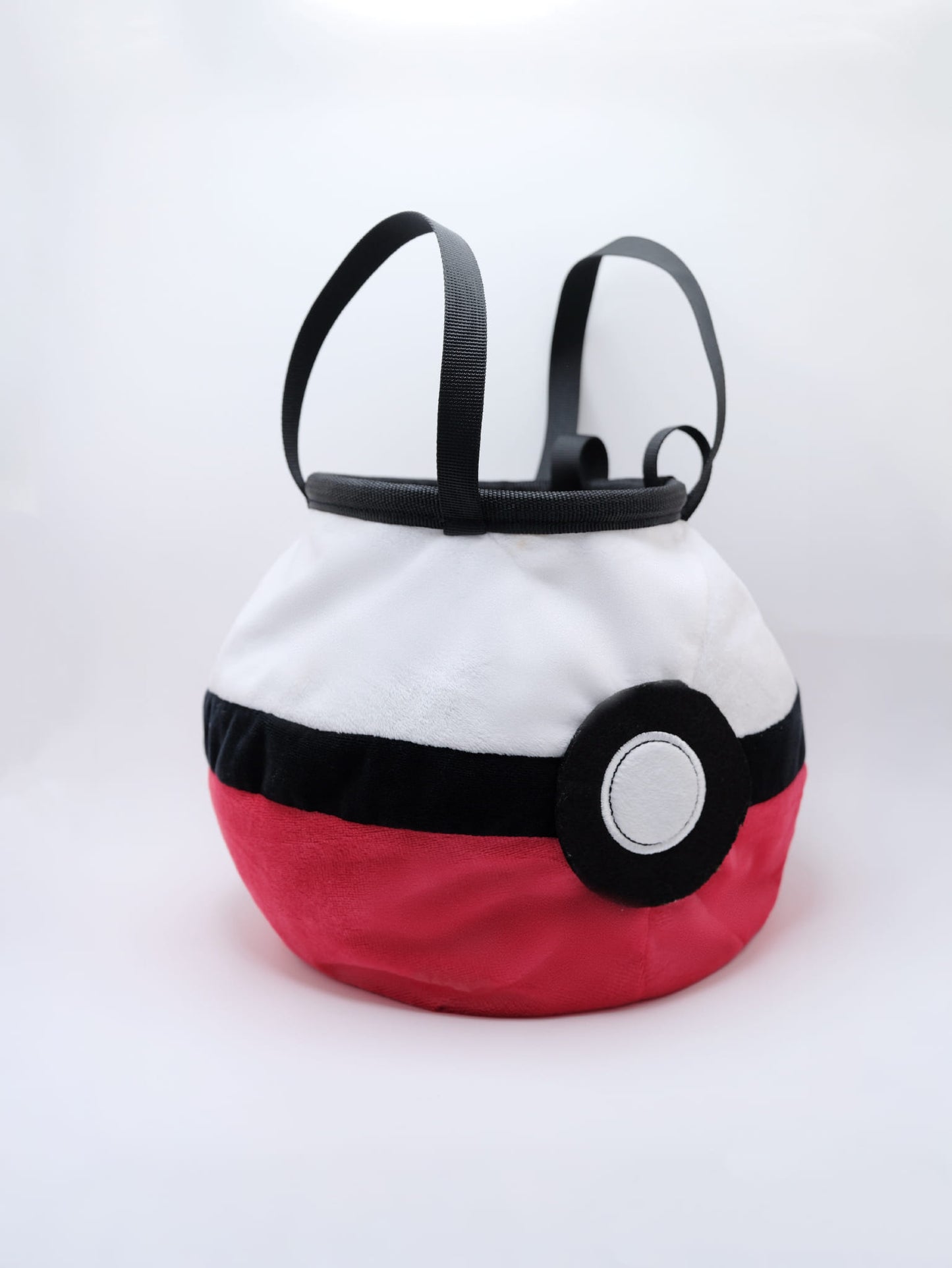 A soft and fluffy Poke Ball plush chalk bag by Fatworm. This cute yet functional climbing gear features the iconic red, white, and black design in a long-durable handmade construction. The perfect climbing gift for climbers who love gaming accessories.