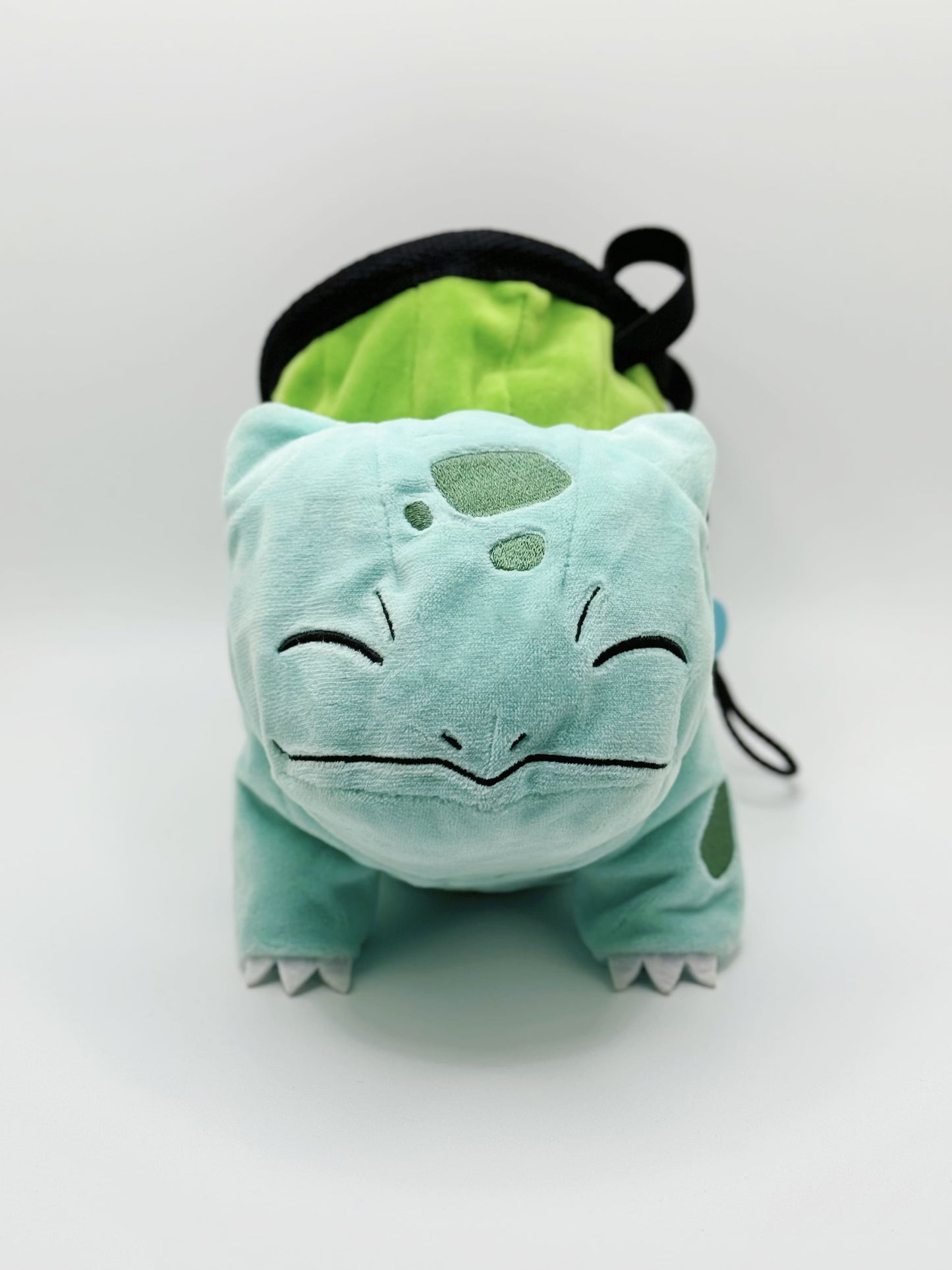 Sleeping Bulbasaur cute plush chalk bag featuring two eyes closed and a peaceful grin. A functional Grass-type plush and the perfect climbing gift for climbers.