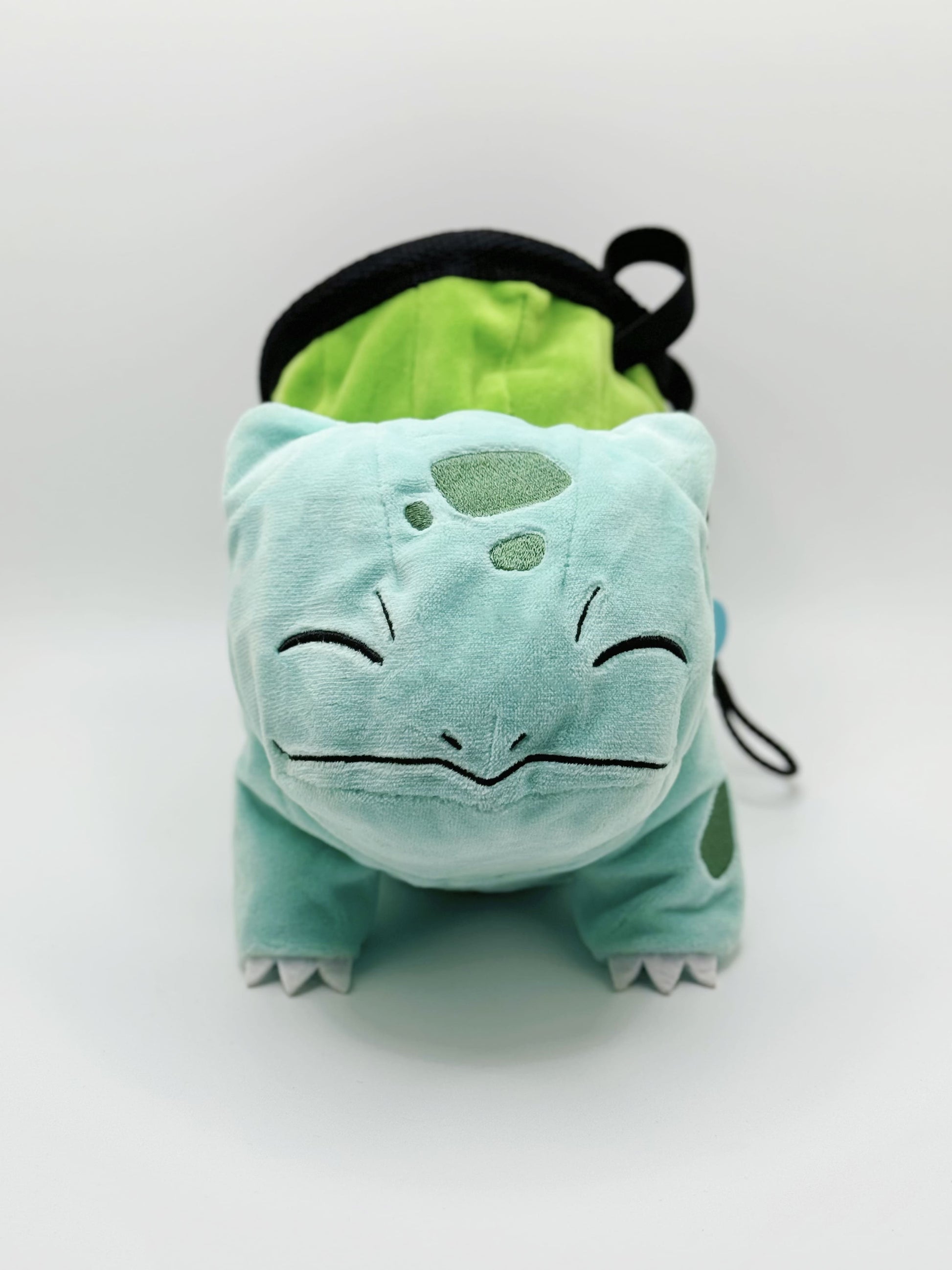 Sleeping Bulbasaur cute plush chalk bag featuring two eyes closed and a peaceful grin. A functional Grass-type plush and the perfect climbing gift for climbers.