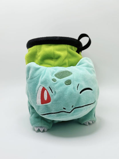 Winking Bulbasaur cute plush chalk bag with one eye closed and a cheeky smile. High-quality, functional climbing gear with a compact chalk-saver design.