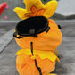 Handmade orange plush Torchic fire chick climbing chalk bag for bouldering. Features yellow feather tufts and a cute bird silhouette. High-quality plush bouldering gift with a 12cm reinforced rim, secure drawstring, and deep black fleece lining for rock climbing.