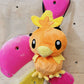 Handmade orange plush Torchic fire chick climbing chalk bag for bouldering. Features yellow feather tufts and a cute bird silhouette. High-quality plush bouldering gift with a 12cm reinforced rim, secure drawstring, and deep black fleece lining for rock climbing.